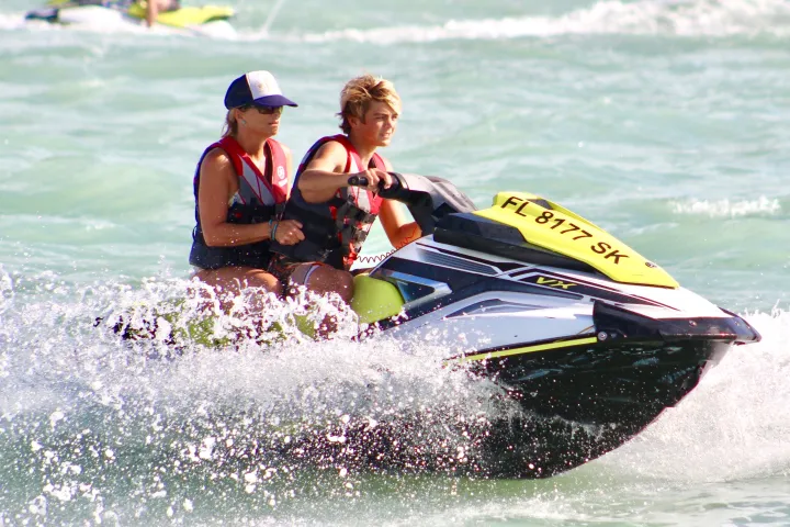 Mother & Son riding a double jetski in the Atlantic Ocean