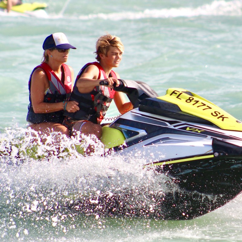 Mother & Son riding a double jetski in the Atlantic Ocean