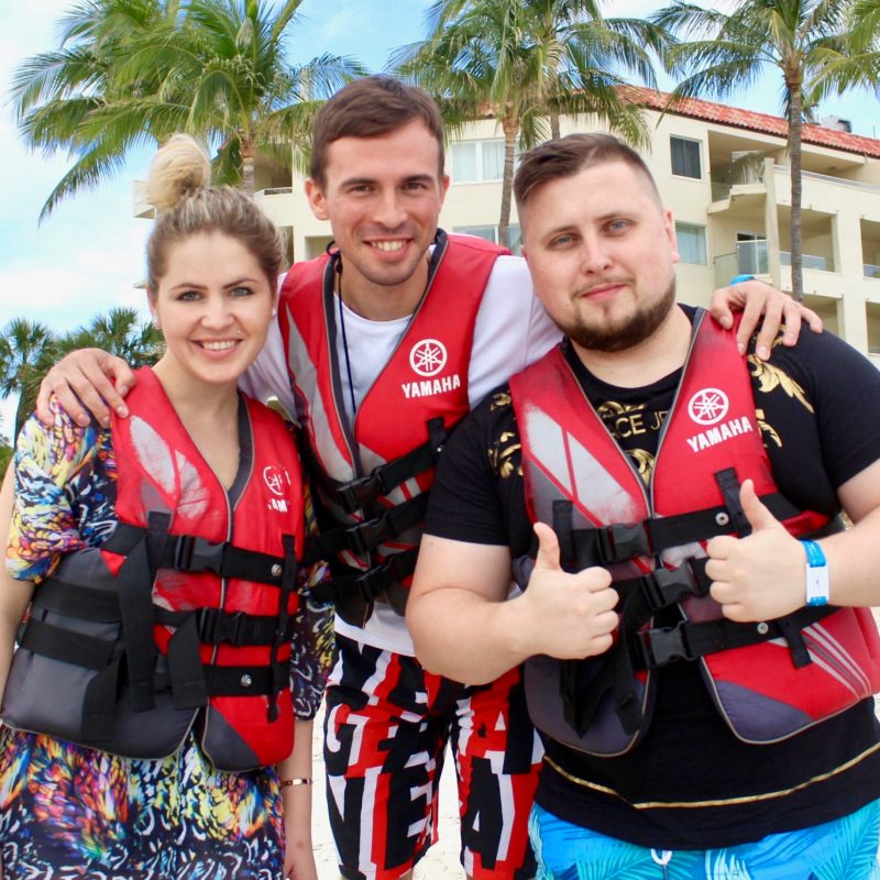 a group of people posing for the camera on the Casa Marina beach