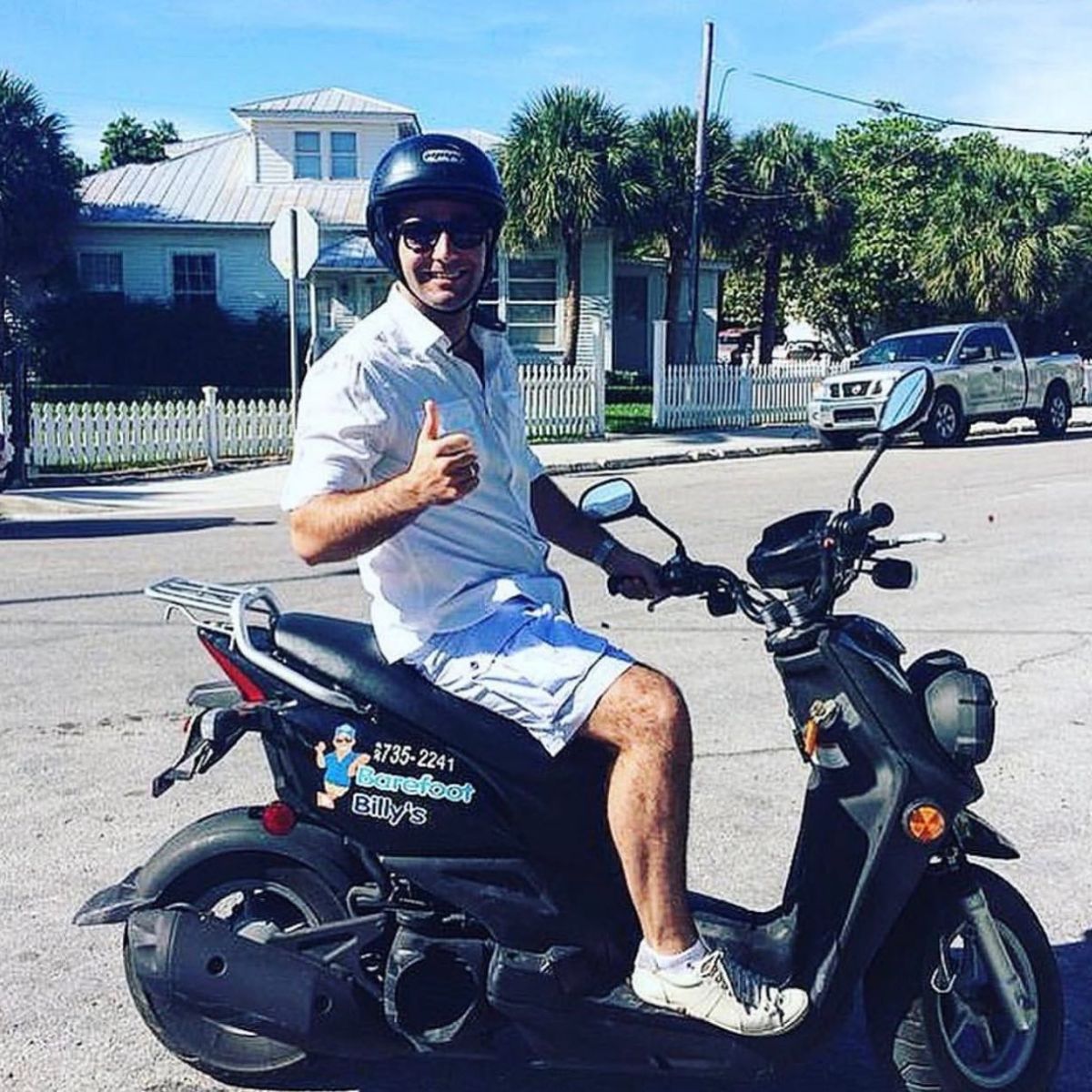 a man wearing a helmet riding a motorcycle