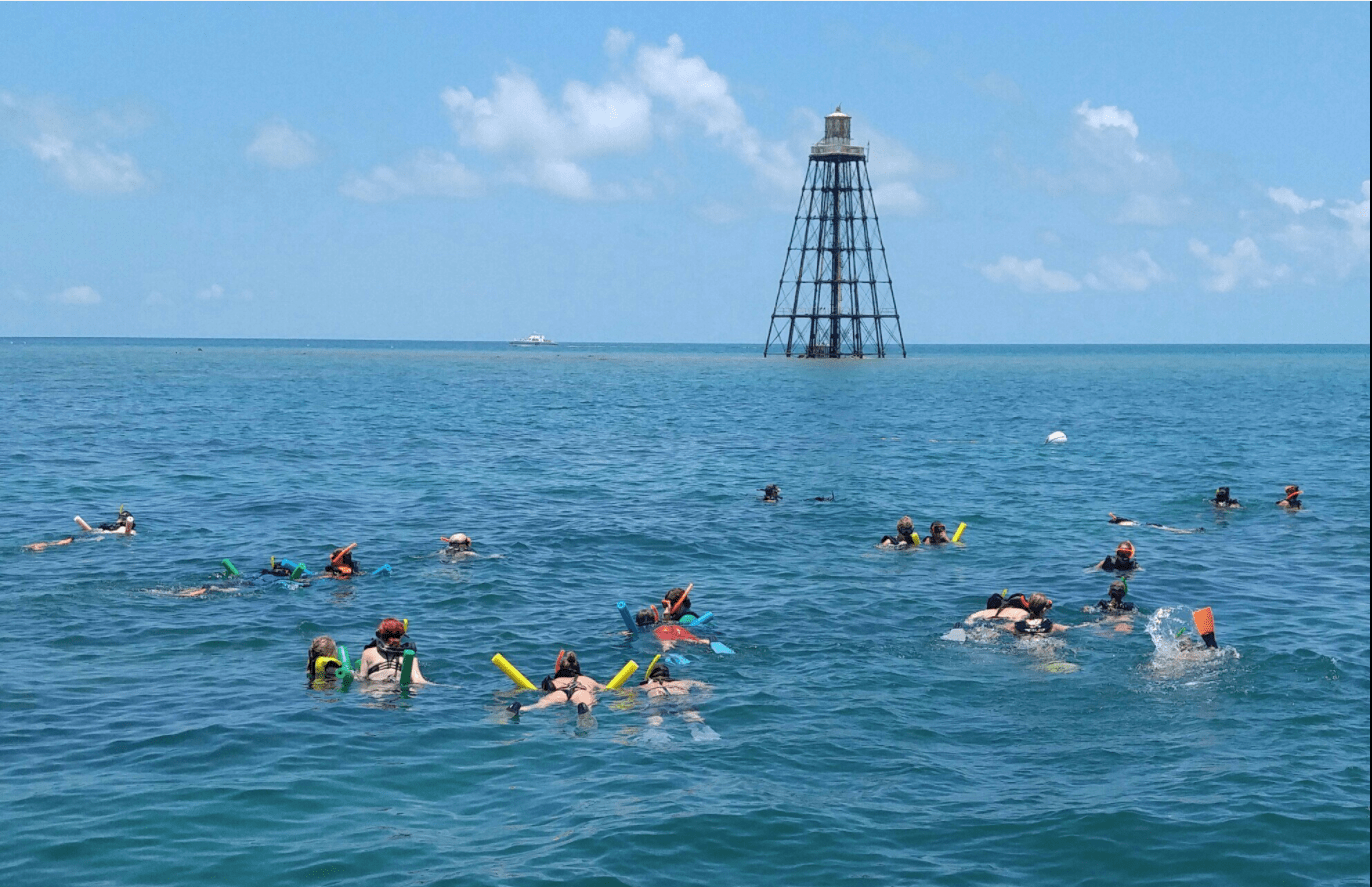 a group of people on a boat in a large body of water