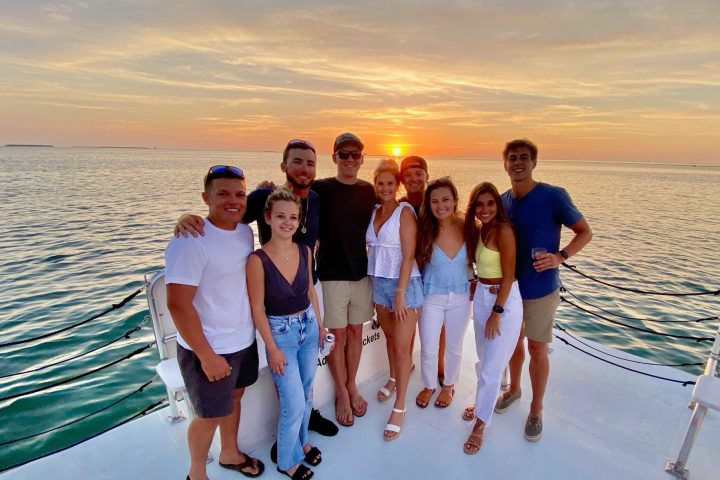 a group of people on a beach posing for the camera