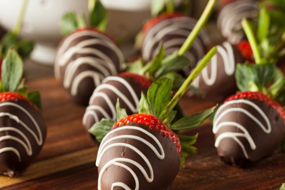 a chocolate covered roses on top of a wooden table